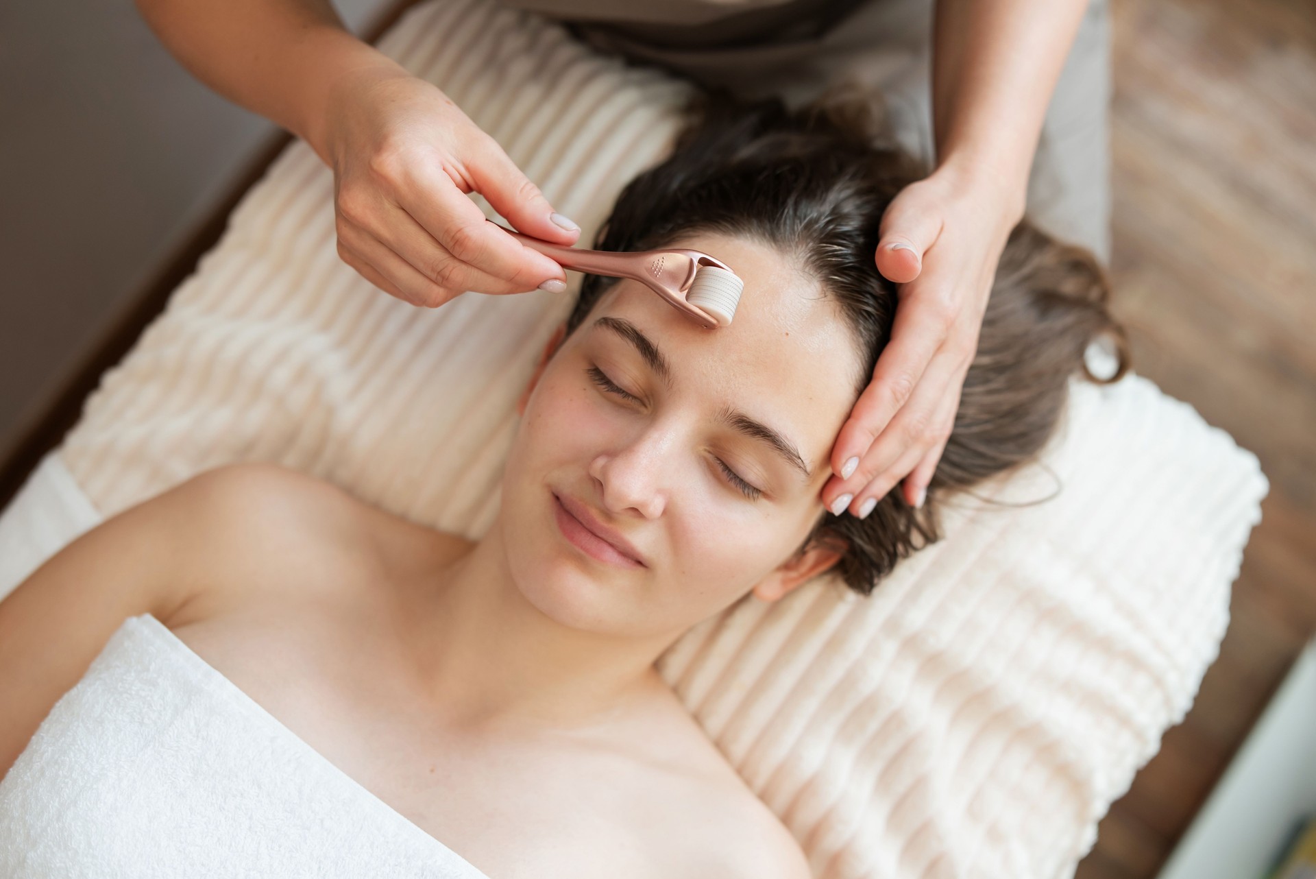 Young pretty woman at the beautician, microneedle mesotherapy treatment