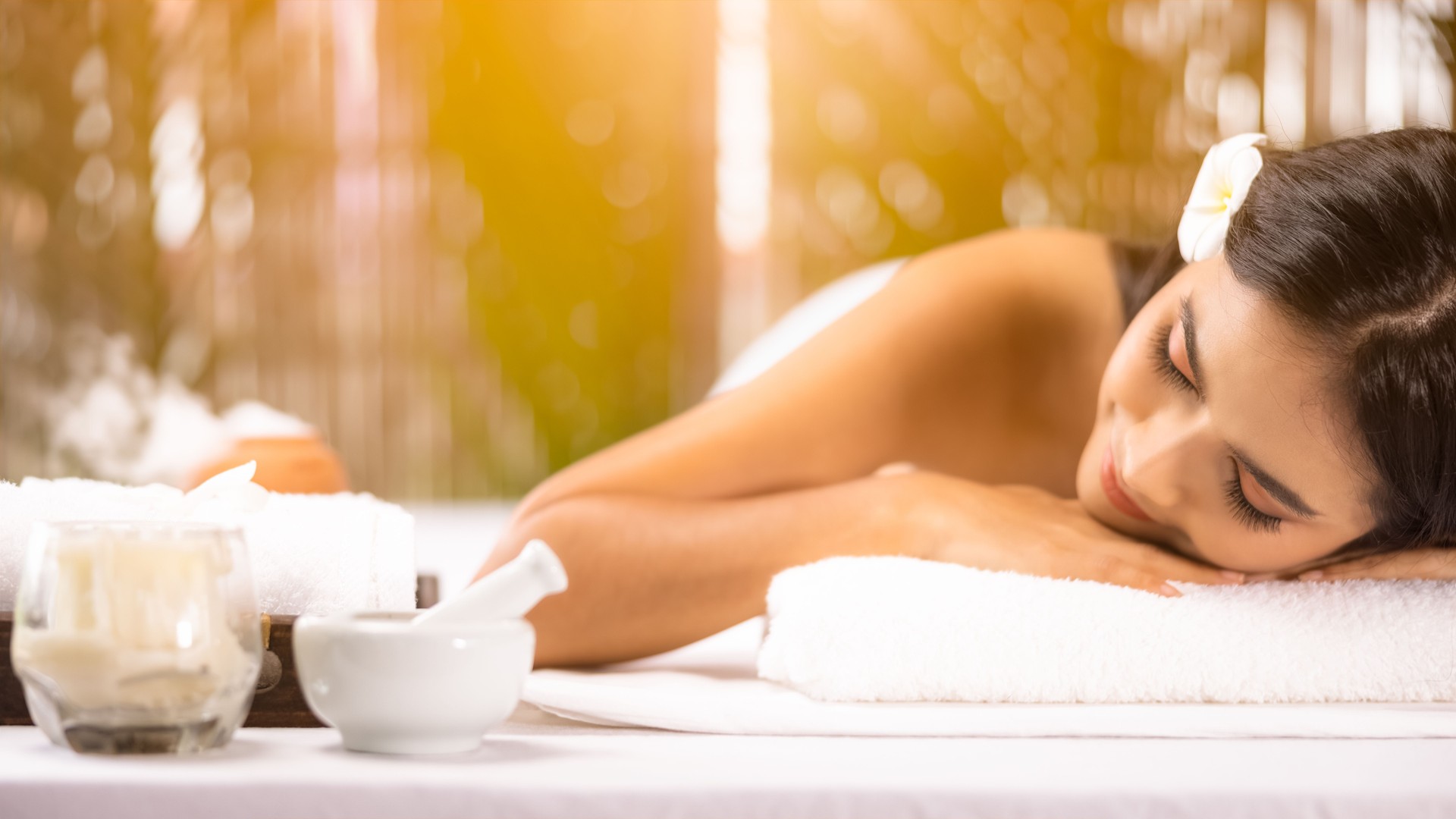 beauty, spa, resort and relaxation concept - beautiful woman in spa salon