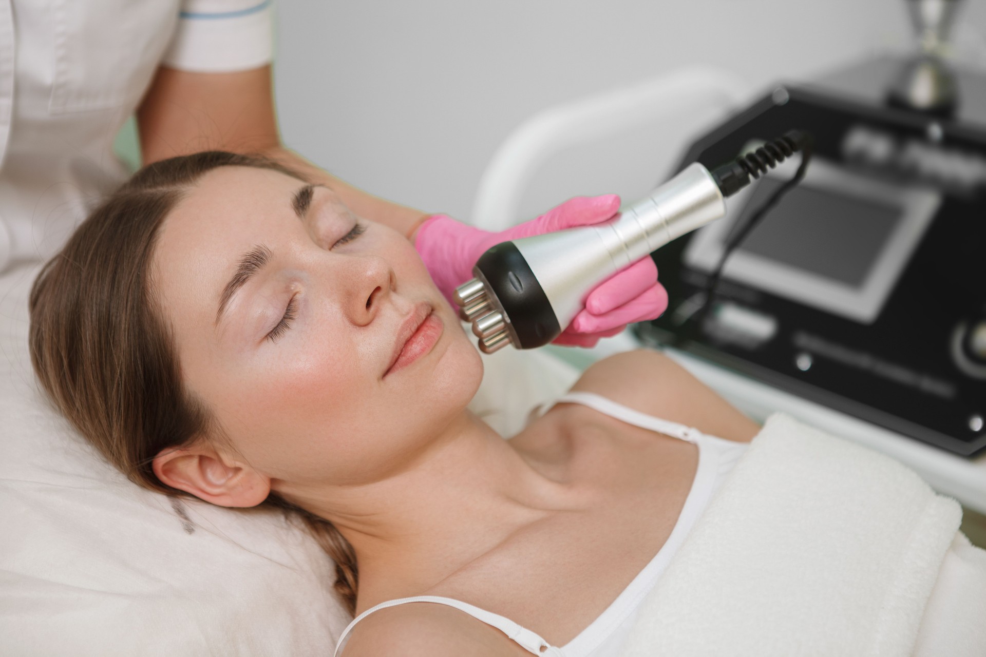 Woman getting beauty treatment at cosmetology clinic